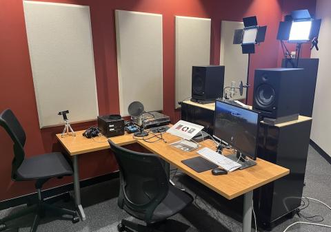 room with sound panels, a desk, and recording equipment